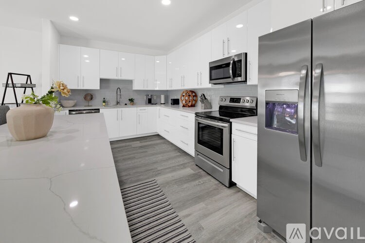 A modern kitchen with a refrigerator on the right side.