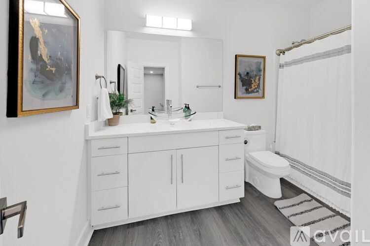 A bathroom with a white cabinet and a white toilet.