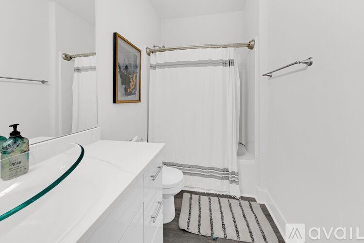 A bathroom with a white tub and a white toilet.