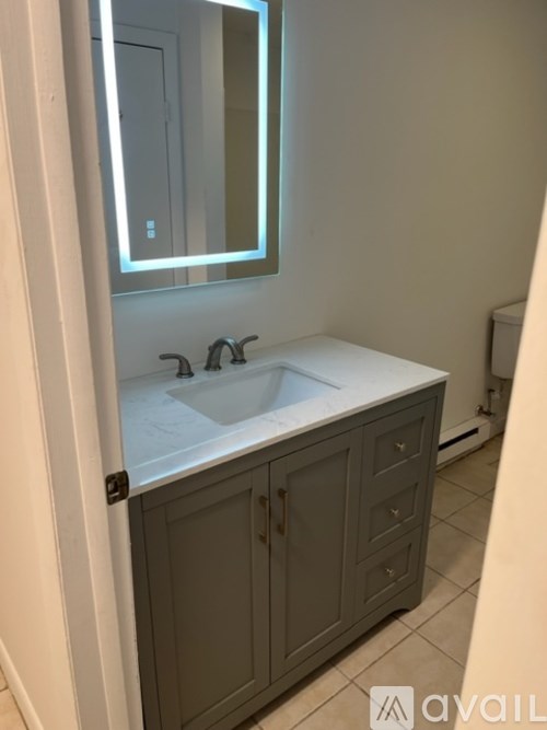 A bathroom with a sink and a mirror.