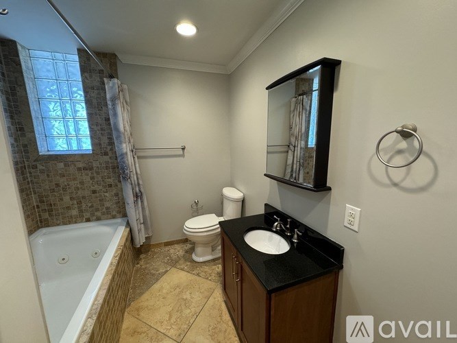 A room with a ceiling fan and sliding glass doors.