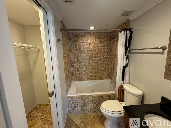 A bathroom with a toilet, a bathtub, and a shower.
