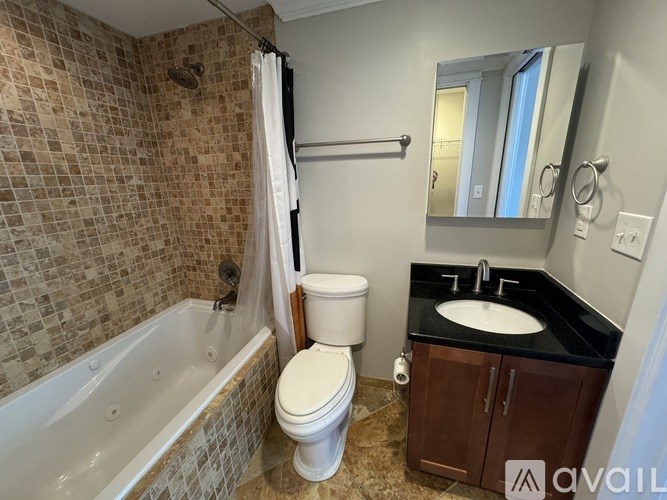 A bathroom with a toilet, sink, and bathtub.