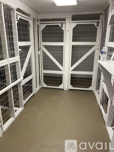A white bathtub with a shower head and a window in a tiled bathroom.