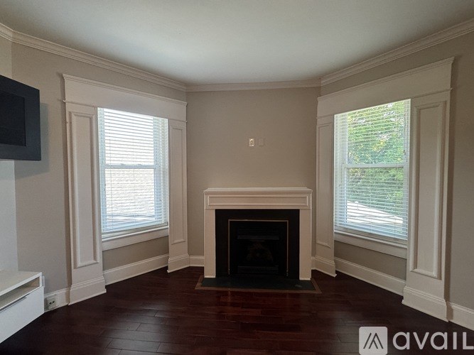 A living room with a fireplace and a television.
