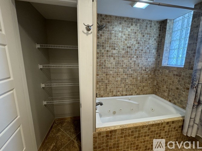 A bathroom with a tiled shower and a bathtub.