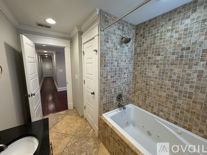 A bathroom with a tiled shower and a bathtub.