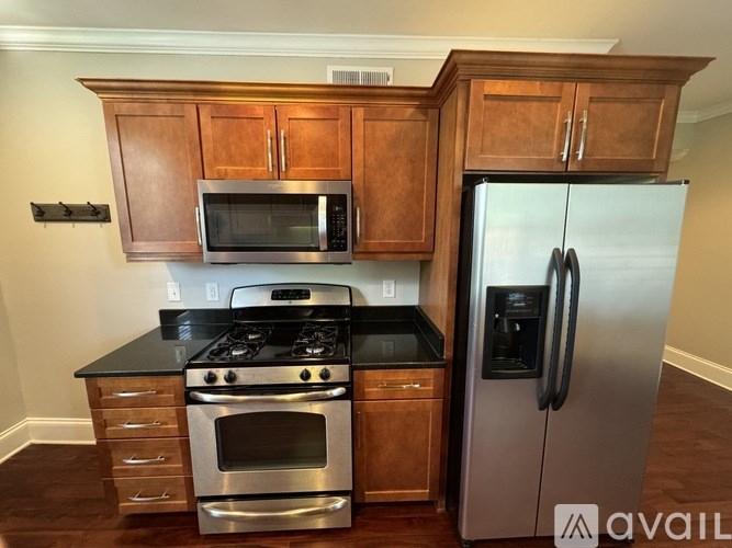 A kitchen with wooden cabinets and stainless steel appliances.