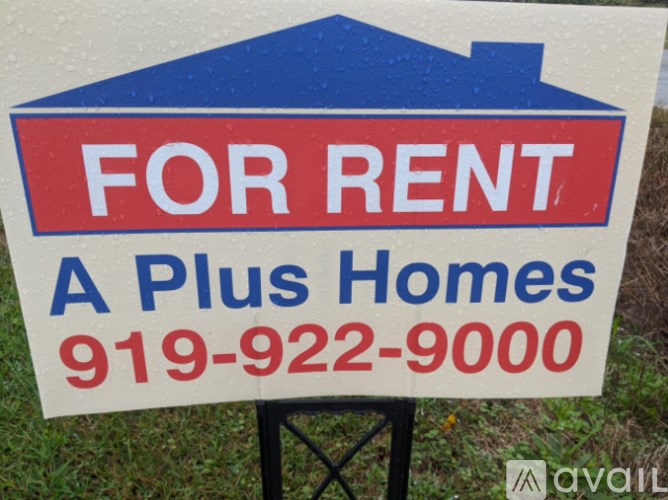 A blue and red For Rent sign for A Plus Homes.