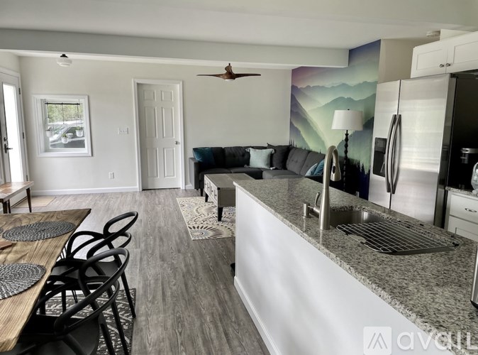 A modern kitchen with a dining table and chairs.