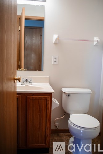 A white toilet sits next to a sink in a bathroom.