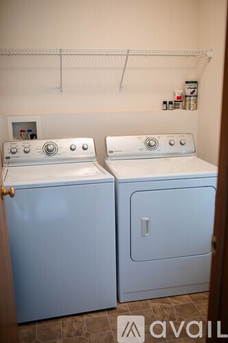 Two front loading washing machines in a laundry room.