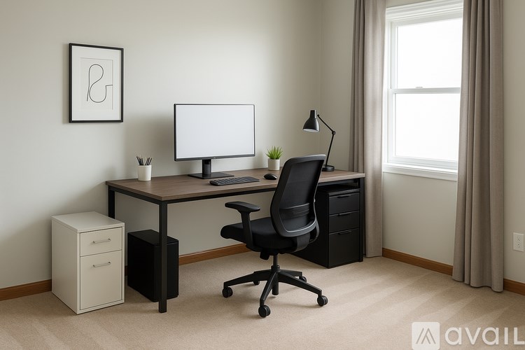 A wooden desk with a laptop and a lamp on it.