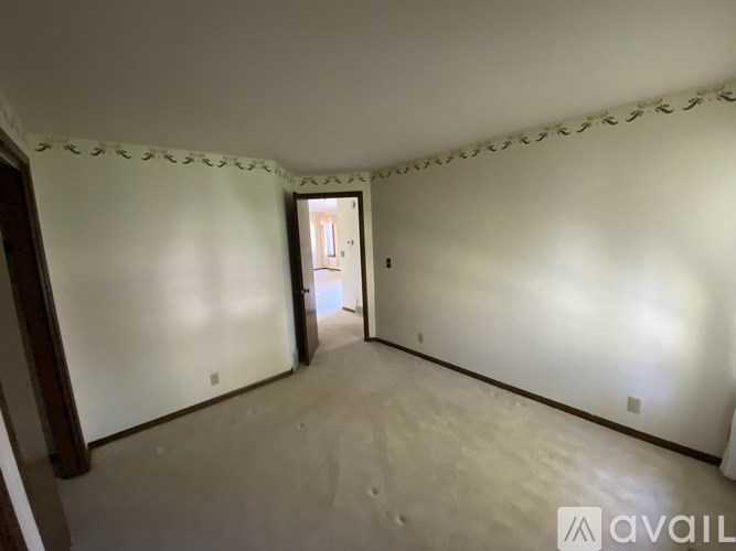 A room with a doorway leading to another room.