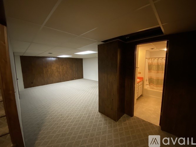 A room with a tiled floor and a doorway leading to another room.