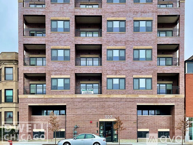 A tall brick building with the number 927 on the front.