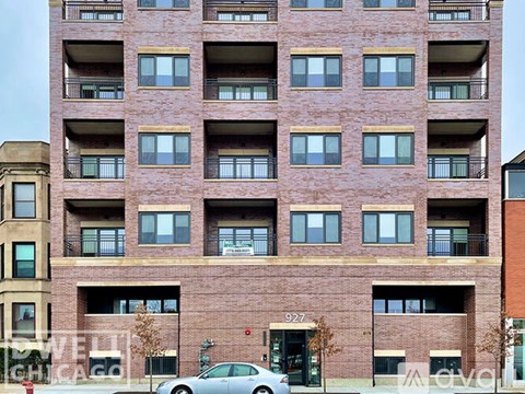 A tall brick building with the number 927 on the front.