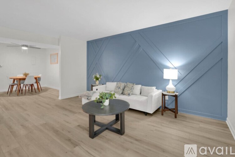 A living room with a white couch and a coffee table.