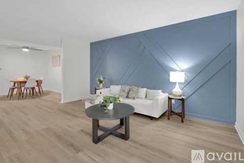 A living room with a white couch and a coffee table.