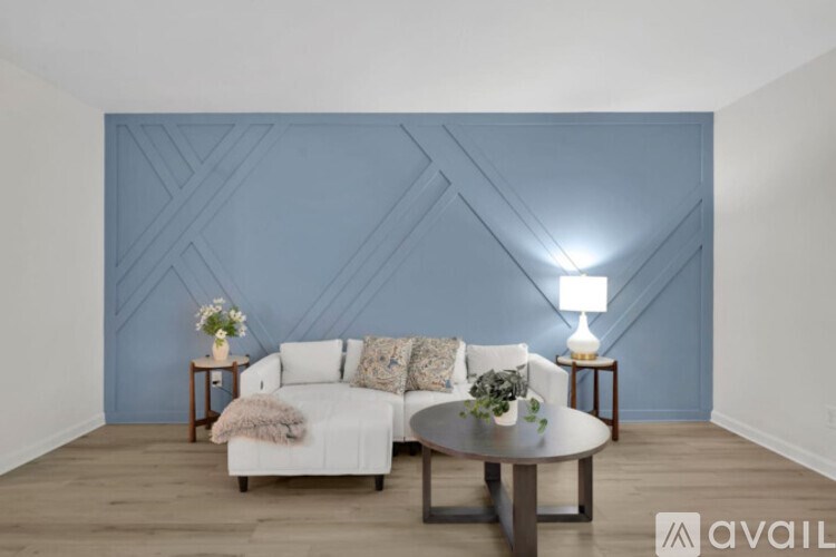 A living room with a white couch and a wooden coffee table.