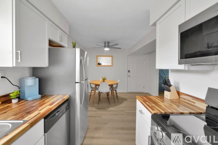 A kitchen with a wooden countertop and stainless steel appliances.