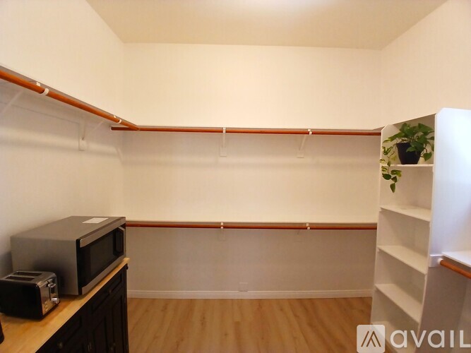 A small kitchen with a microwave and toaster on the counter.