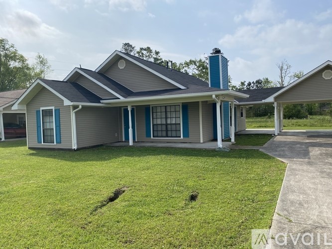 A house with a blue roof and a chimney.