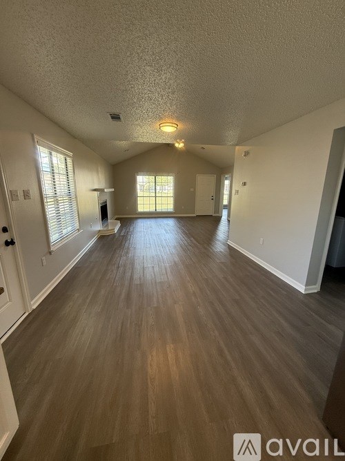 A white bathtub with a shower head and faucet.