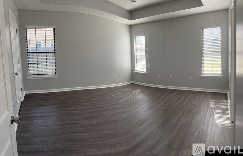 A room with a fireplace and a window with blinds.