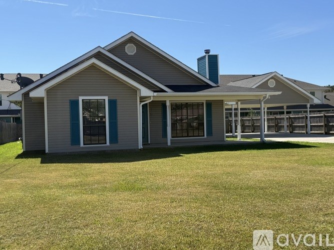 A spacious room with wooden flooring and a television mounted on the wall.