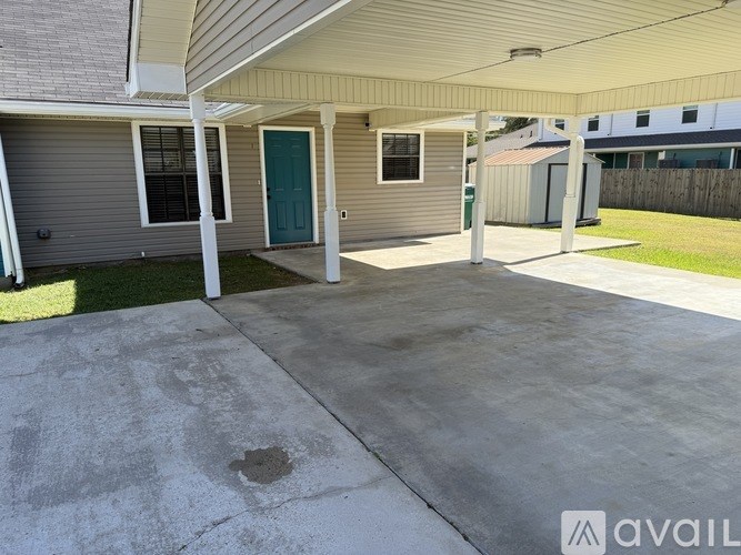 A room with wooden flooring and a window with blinds.