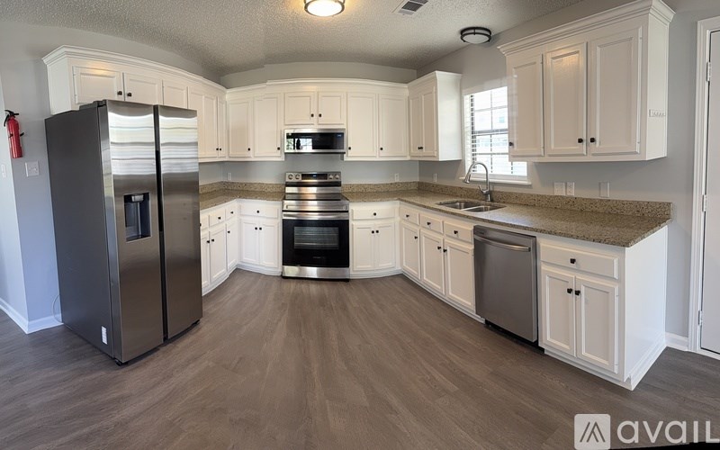 A room with a window and wooden flooring.