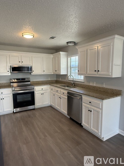 A room with a grey floor and a white door.