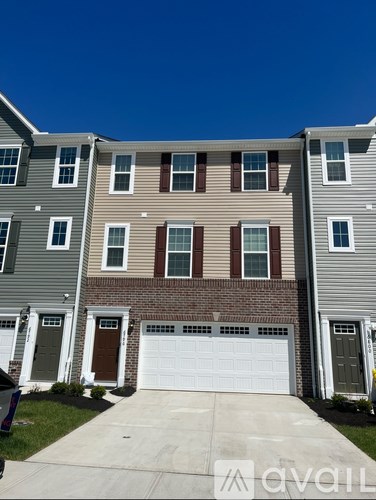 A row of houses with garages in front.