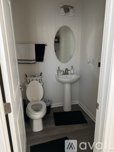 A white toilet and sink in a small bathroom.