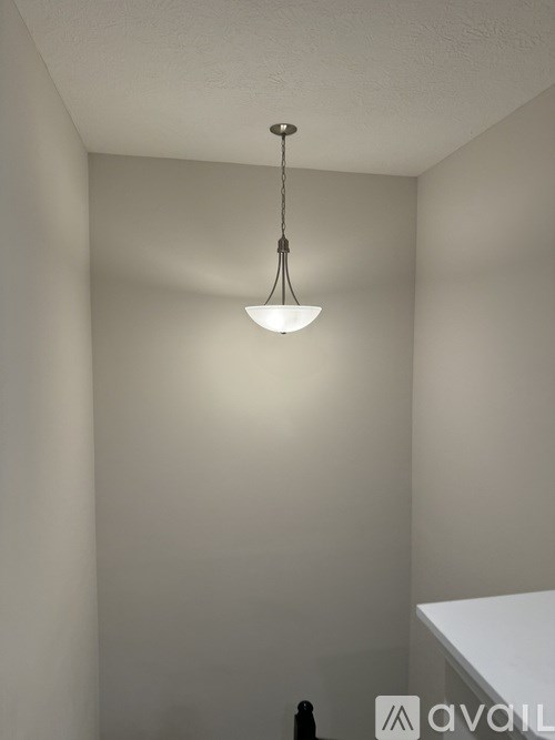 A light fixture hangs from the ceiling in a room.