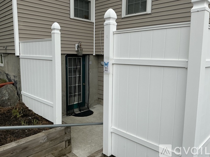 A green door with bars is the only entrance to a house.