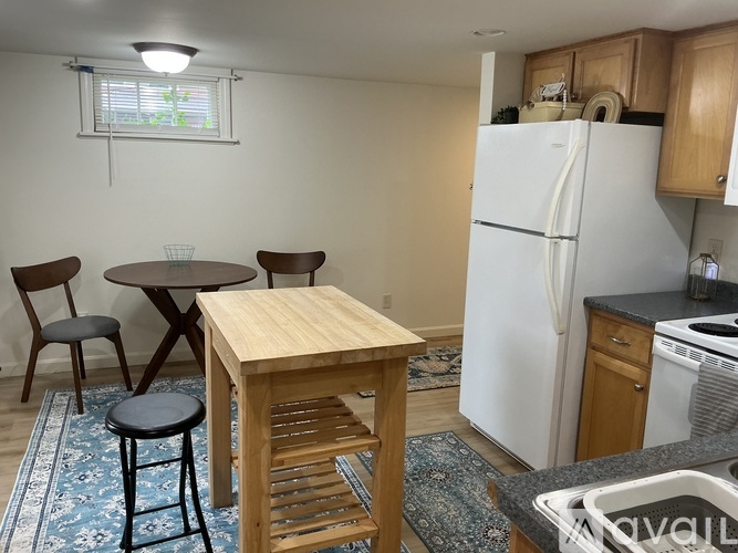 A kitchen with wooden cabinets and a white door.