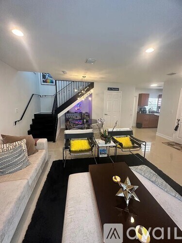 A living room with a white couch and a coffee table with a star decoration on it.