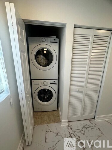 A washer and dryer are in a small closet.