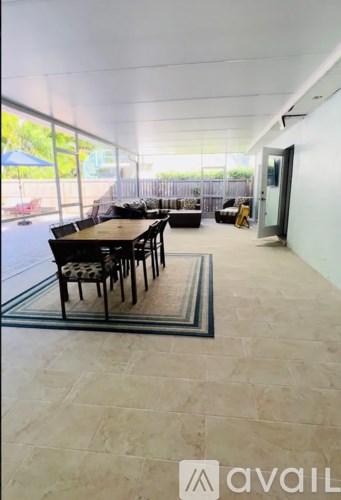 A dining area with a table and chairs is available for rent.