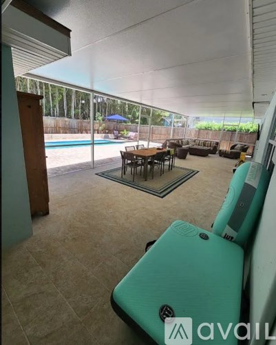A living room with a pool in the backyard.