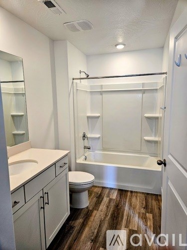 A bathroom with a toilet, sink, and bathtub.