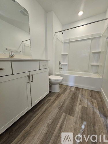 A bathroom with a toilet, sink, and bathtub.