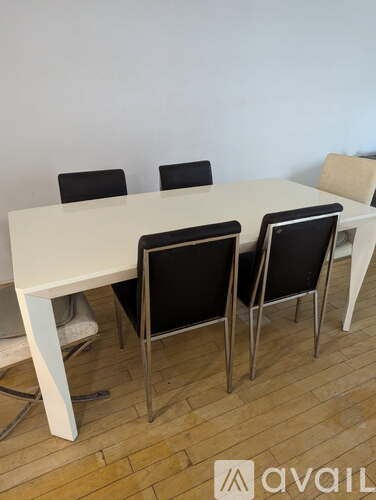 A white table with four chairs and a logo on the table.