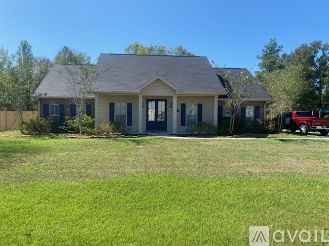 A house with a red car parked in front.