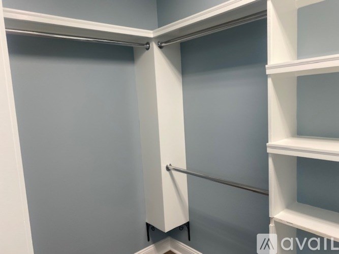 A white closet with shelves and a sliding door.