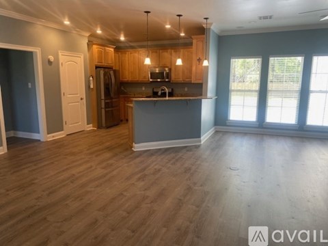 A kitchen with wooden cabinets and a grey countertop.