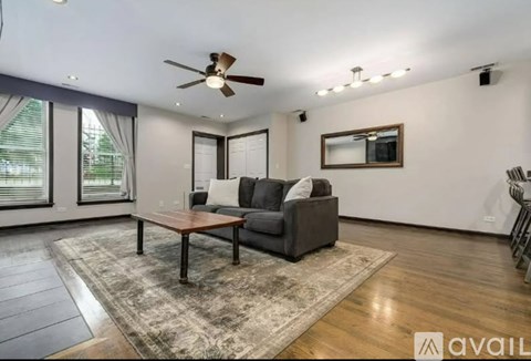 A living room with a grey couch and a wooden coffee table.