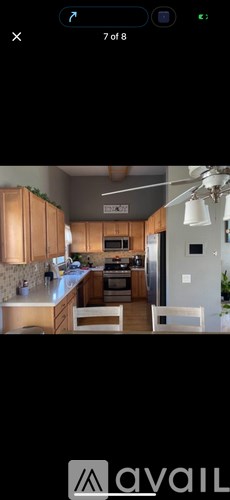 A modern kitchen with wooden cabinets and a central island.